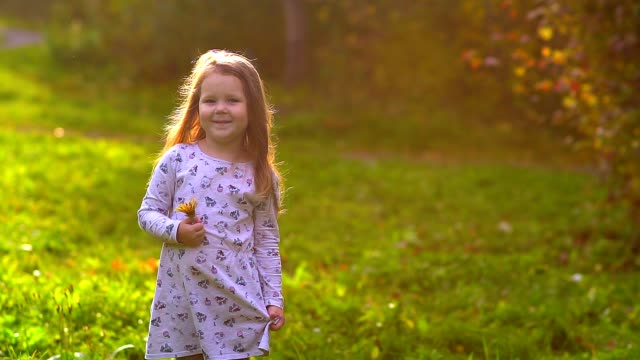 little-girl-with-a-flower-at-sunset