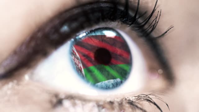 woman-blue-eye-in-close-up-with-the-flag-of-belarus-in-iris-with-wind-motion.-video-concept