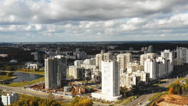 Drone-flying-above-beautiful-autumn-megapolis-panorama-of-Minsk,-Belarus,-high-rise-tower-blocks-under-construction.