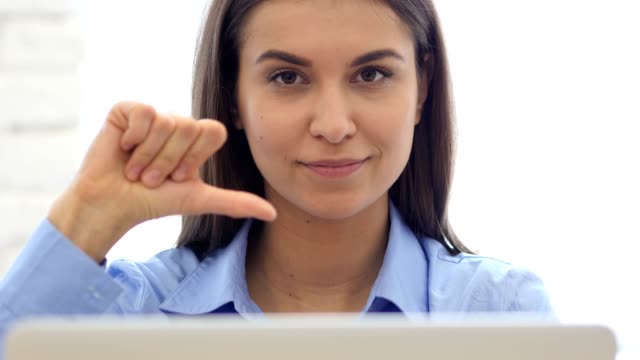 Thumbs-Down,-Frustrated-Woman-Gesture-while-Sitting-in-Office