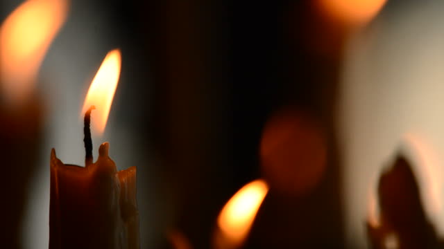 Candle-with-candles-defocused-in-background