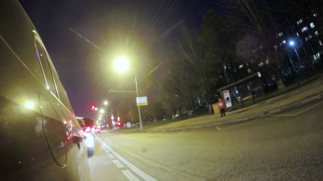 Driving-on-a-night-city-street.-Blurred-motion-time-lapse.-View-from-outside-of-the-cabin.
