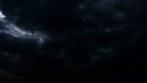 Thunderstorm-clouds-at-night-with-light-rays-from-top.-4K-Timelapse-Loop.