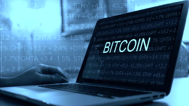 Cryptocurrency-concept-with-stock-market-ticker-scrolling-over-laptop---Bitcoin