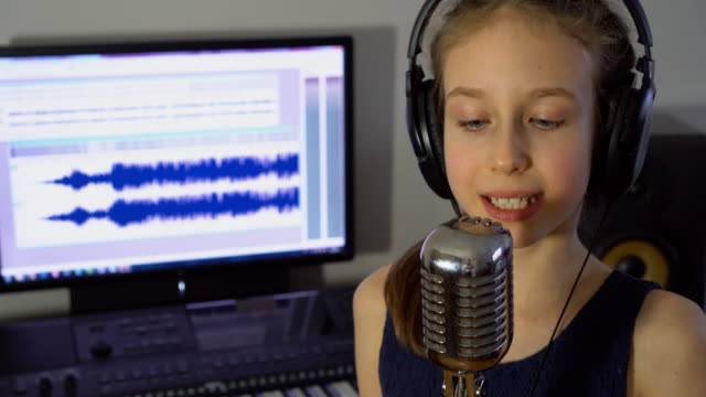 Little-girl-recording-a-song-in-home-recording-studio.