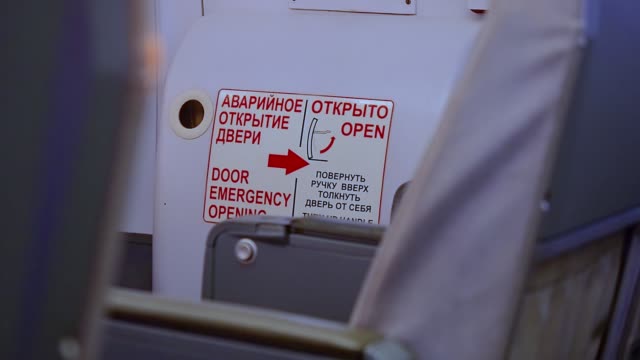 Pointer-to-emergency-exit-in-passenger-compartment-of-passenger-plane