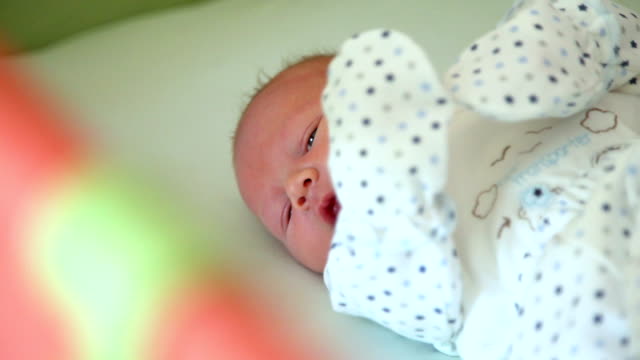 Newborn-Baby-Laying-in-the-Crib