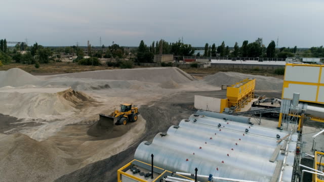 Asphalt-Concrete-Plant-With-Running-Bulldozer.-Aerial-View.