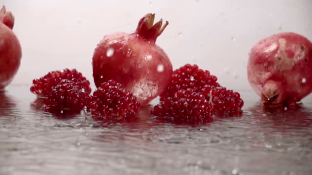 Falling-drops-of-water-on-pomegranate.-Slow-motion