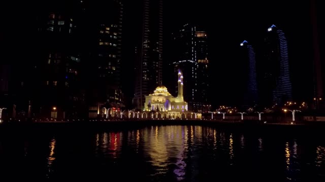 Nachtansicht-auf-wunderschöne-kleine-Moschee-in-Dubai-Marina,-Anzeigen-von-schwimmenden-Vergnügungsdampfer