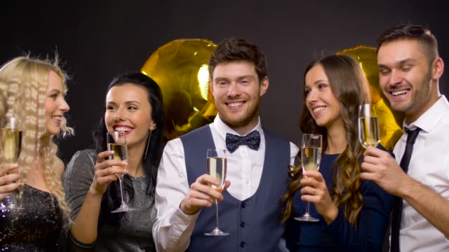 happy-friends-with-champagne-glasses-at-party