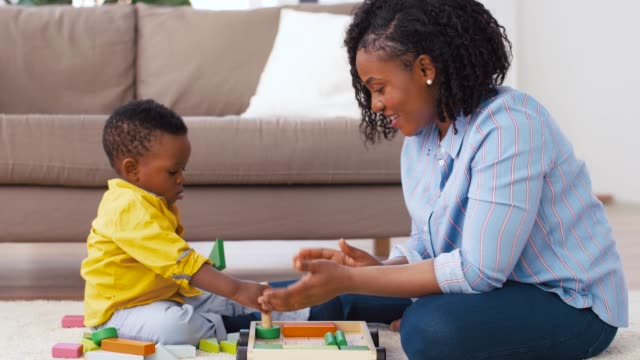 mother-and-baby-playing-with-toy-blocks-at-home