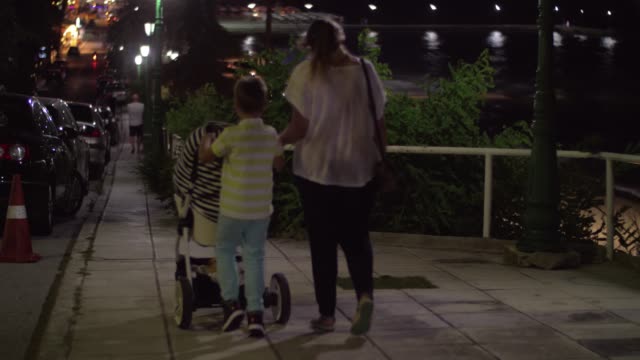 Mother-having-evening-walk-with-elder-son-and-baby