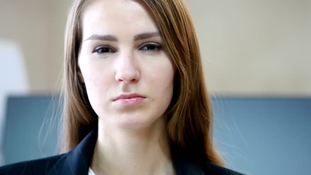 Close-Up-of-Serious-Woman-Face-in-Office