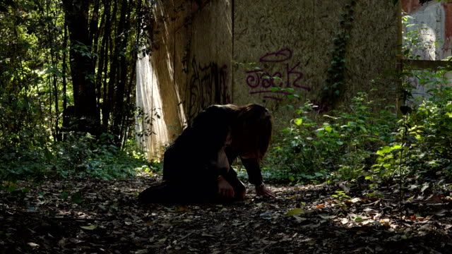 lonely-scared-Crying-woman--in-forest-,Kneeling-on-the-floor