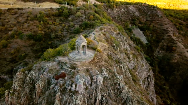 A-small-chapel-on-the-mountain-edge-against-at-the-morning.-Aerial-shot