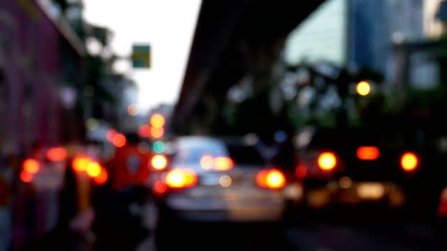 4K.-blurry-traffic-jam-on-the-road-in-the-dusk-at-Bangkok-city-,-Thailand