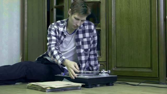man-with-vinyl-records-in-hands-listens-to-the-music