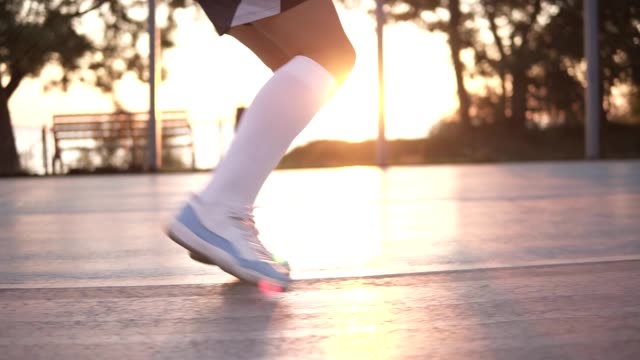 Close-up-shot-of-female-basketball-player-legs-doing-dribbling-exersice-very-quickly-without-ball,-training-outdoors-on-the-local-court