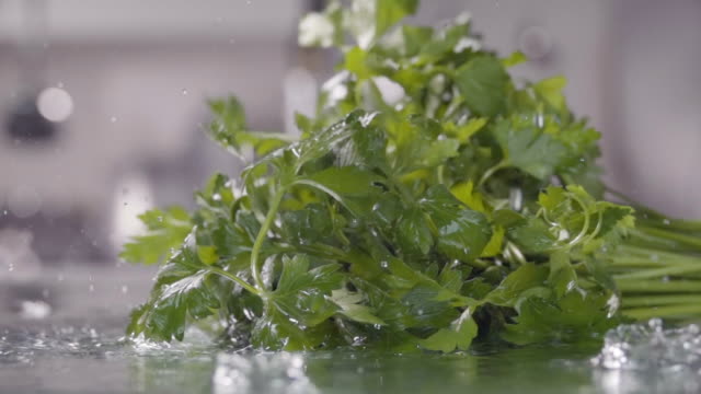 Falling-of-parsley-into-the-wet-table.-Slow-motion-240-fps