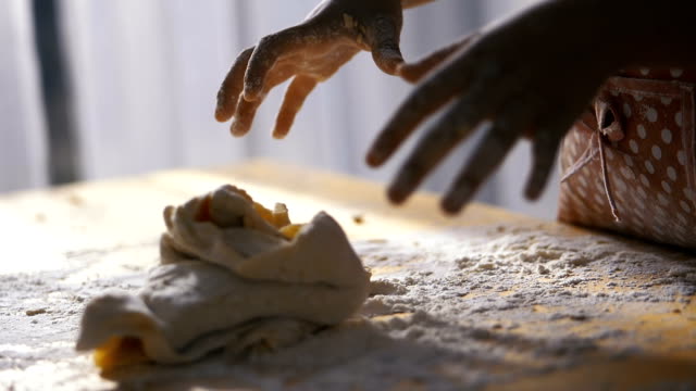 Kids-hands-preparing-dough-for-pizza-or-bread-on-table,-slow-motion.