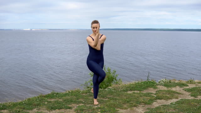 Pretty-girl-in-classical-yoga-pose,-energy-concentration