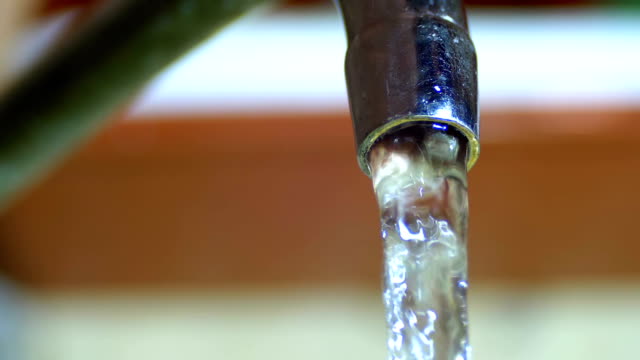 Water-Running-from-the-Tap-into-a-Sink.-Slow-Motion