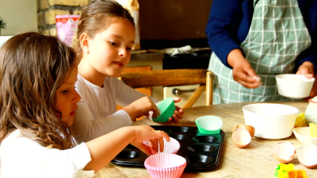 Siblings-preparing-food-with-family-in-kitchen-4k