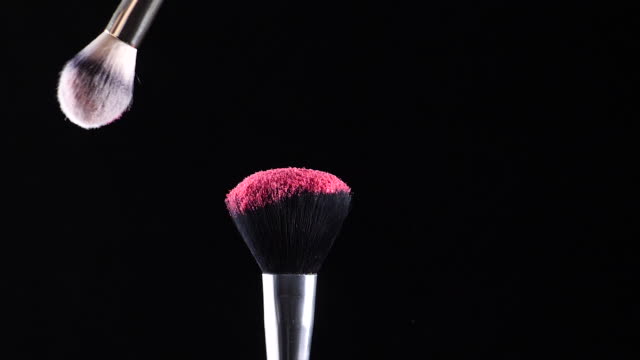 two-make-up-brushes-collide-creating-an-explosion-of-colored-powder-1
