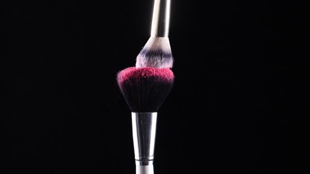 two-make-up-brushes-collide-creating-an-explosion-of-colored-powder-2