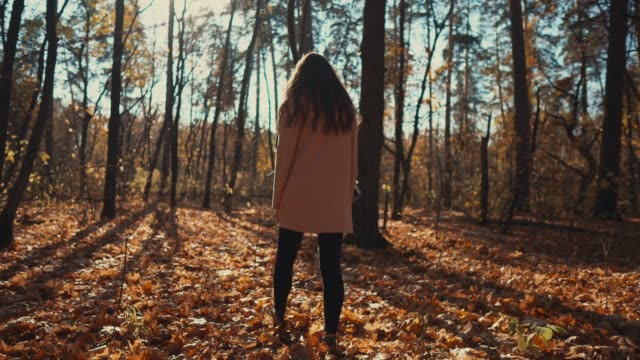 Lovely-girl-in-autumn-forest-in-the-morning.