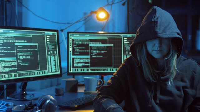 female-hacker-showing-middle-finger-in-dark-room