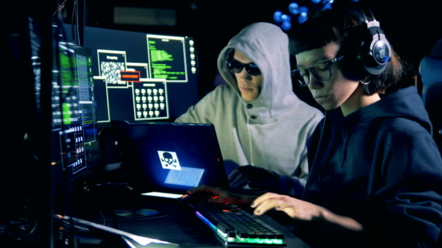 Male-hacker-is-assisting-to-a-female-one-while-working