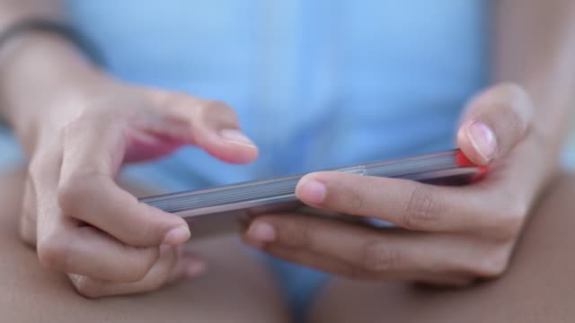 Closeup-Of-Hands-Of-Young-Woman-Using-Phone