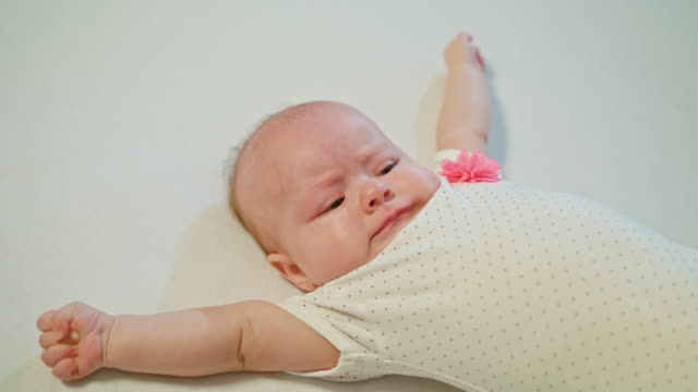 Babymädchen-auf-Bett-anfängt-zu-weinen