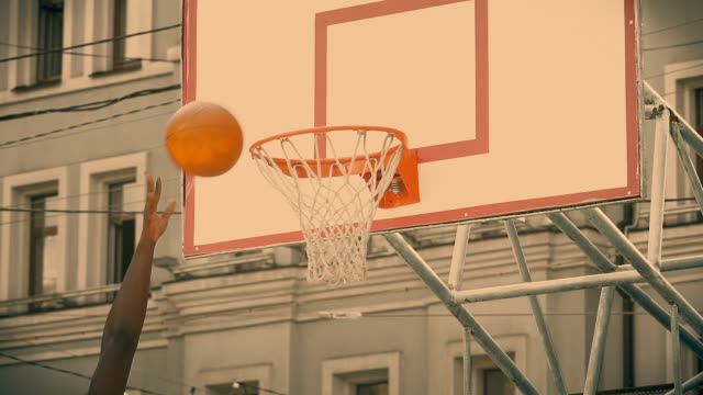 Player-of-basketball-team-throwing-ball-into-basket,-winning-goal,-success