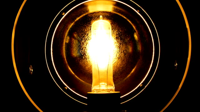Close-up-light-bulb.-Filament-gradually-turns-on-and-off