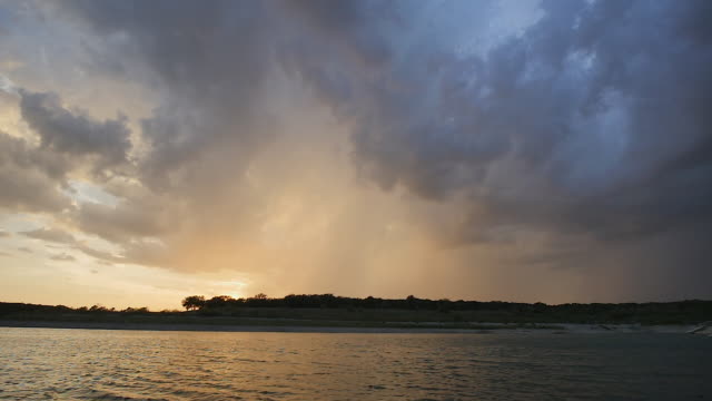 Large-Storm-with-Lightning-at-Sunset-Over-Large-Lake