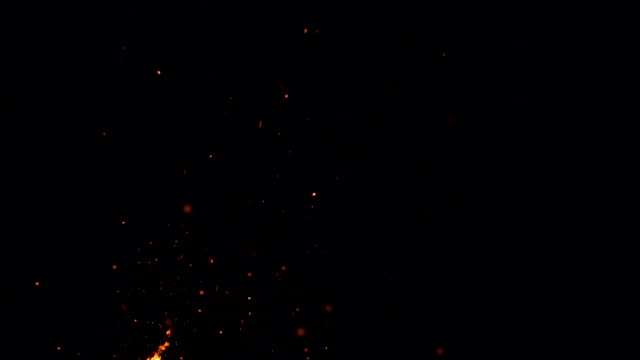 high-speed-shot-of-fire-flames-and-glowing-ash-particles-on-black-background