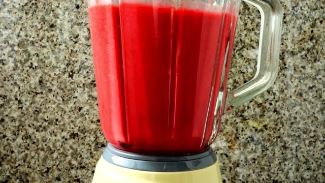 Preparation-in-the-blender-of-a-cocktail-from-raspberry,-bananas-and-apples.	Process-of-preparation-of-cocktail.