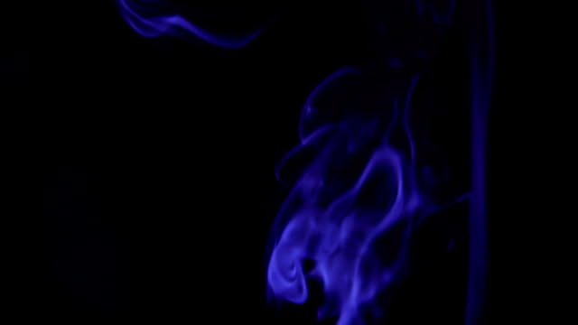 Blue-Steam-Rises-from-up.-Blue-smoke-over-a-black-background.-Smoke-slowly-floating-through-space-against-black-background.-Slow-Motion.