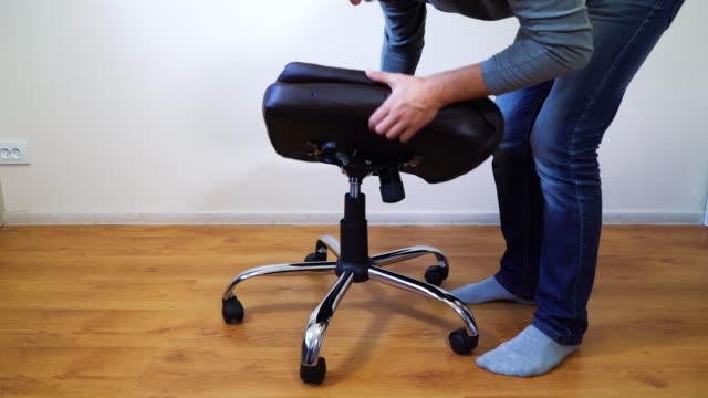 man-assembling-office-chair-at-home
