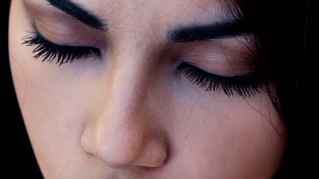 Close-up-portrait-of--sad-pretty-Asian-woman-open-her-eyes