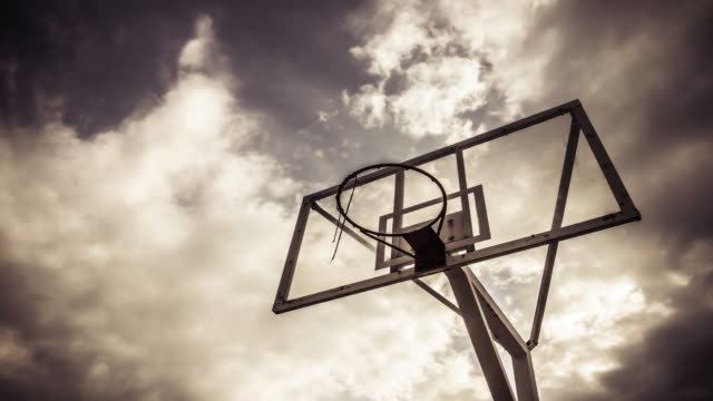 Dramatically-moving-cloud-background-of-A-basketball-ring-in-warm-color