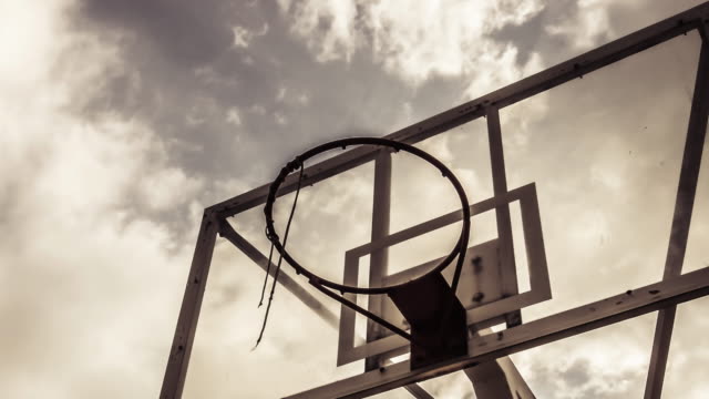 Dramatically-moving-cloud-background-of-A-basketball-ring-in-warm-color