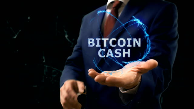 Businessman-shows-concept-hologram-Bitcoin-cash-on-his-hand