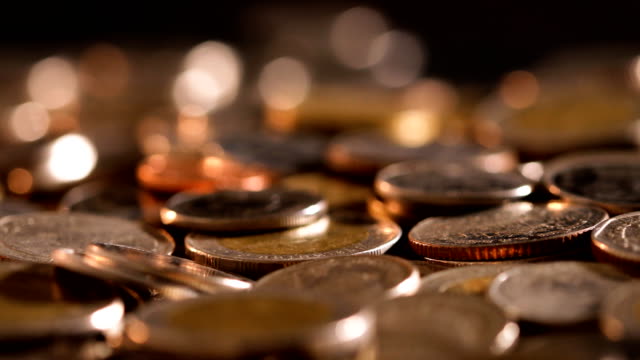 Close-up-money-the-coin-stacking-on--the-floor-in-dark-light-,-business-and-financial-for-money-saving-or-investment-background-concept--,-extremely-close-up-and-shallow-DOF