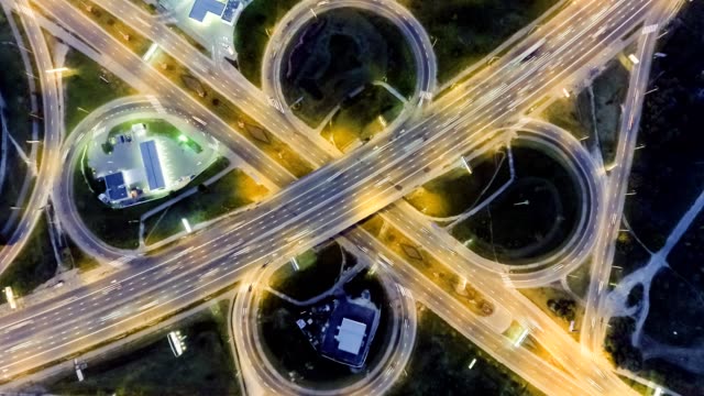 Static-vertical-top-down-aerial-view-of-traffic-on-freeway-interchange-at-night.-timelapse-background