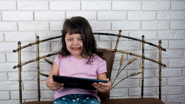 Sad-child-with-a-tablet.
