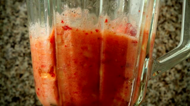 Preparation-of-cocktail-in-the-blender-from-apples,-bananas-and-strawberry.	Slow-motion.